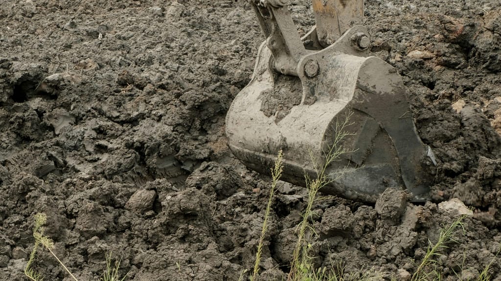 Excavating earth tree stump removal